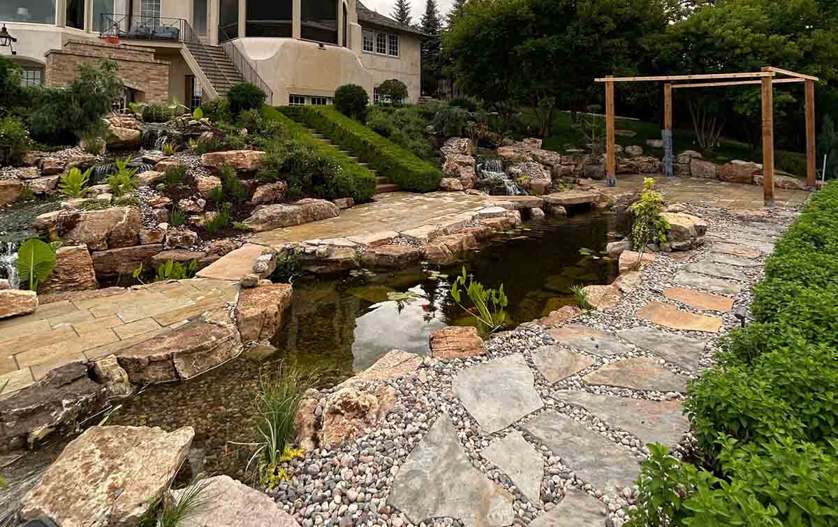 Copy of Large Koi pond with natural bridges and weathered Limestone boulders installation and maintenance